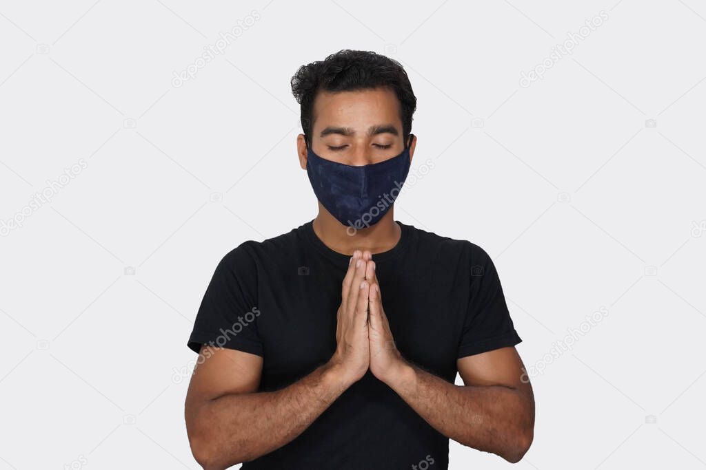 Hindu Man praying to God Wearing mask