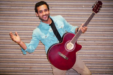 Gitarlı adam gitar çalmaktan hoşlanıyor.