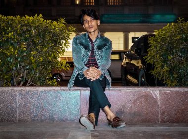 Bahçede oturan rahat adam.