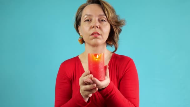 Forty Year Old Woman Red Sweater Holds Burning Candle Blue — Stockvideo