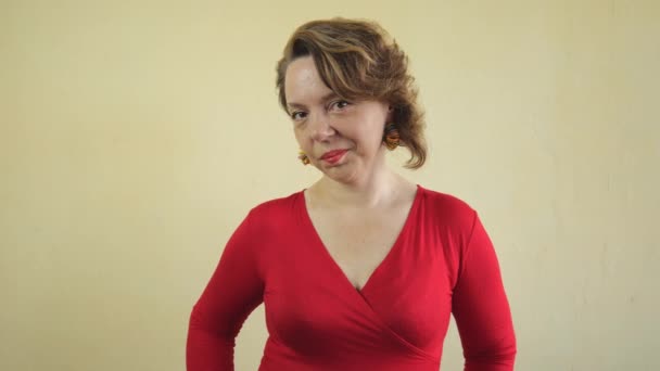 Una Donna Adulta Con Maglione Rosso Erge Contro Muro Luce — Video Stock