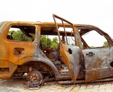 View of the burnt civilian car. Rusty car doors. Stop war. rusty metal