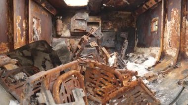 View of the inside of a rusty burnt military vehicle. Stop war. Military equipment
