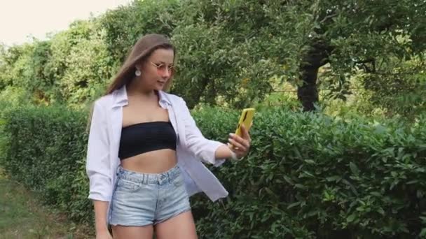 Young Woman Green Foliage Makes Selfie Motion Portrait Woman Slow — Video