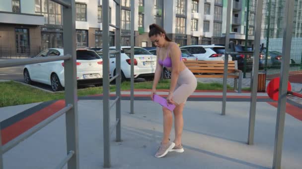Young Athletic Woman Purple Tank Top Stands Sports Ground Houses — 图库视频影像
