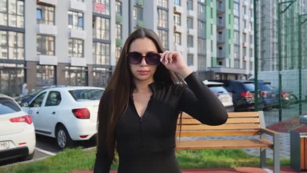 Young Brunette Woman Long Hair Black Suit Walks Sports Ground — ストック動画