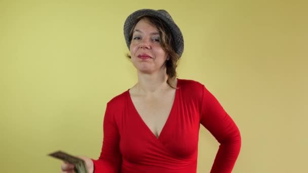 Woman Red Sweater Hat Shows Fifty Dollars Isolated Yellow Background — ストック動画