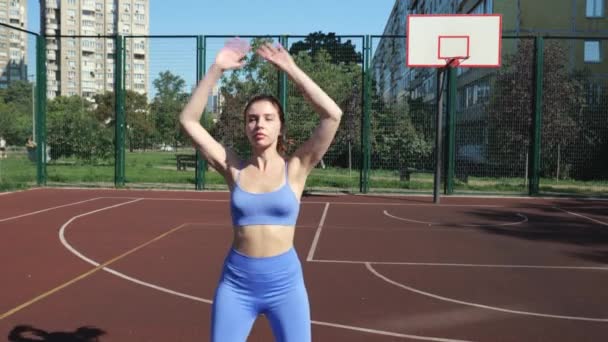 Young Athletic Woman Blue Tracksuit Doing Exercises While Standing Stadium — Stockvideo