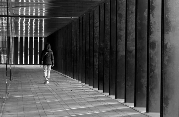 stock image Sad woman walking towards the end of a hallway