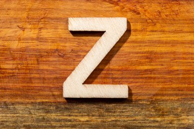 Wooden letters Z on wooden background, top view