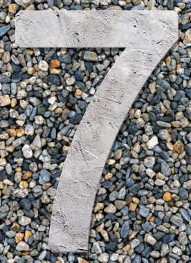 Number 7 with concrete texture, on stones background