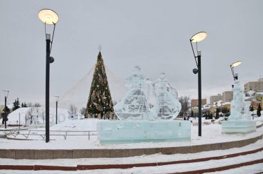 Dmitrov, Russia - January 13, 2022: Ice figures and a Christmas tree on Sovetskaya Square