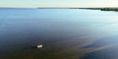 Summertime view on lake winnebago from aerial view with a boat out on the water