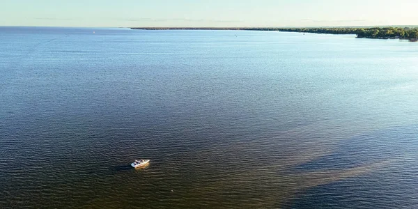 Summertime view on lake winnebago from aerial view with a boat out on the water
