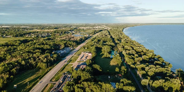 A county highway runs along the outer edge of Lake Winnebago in Wisconsin during the summer