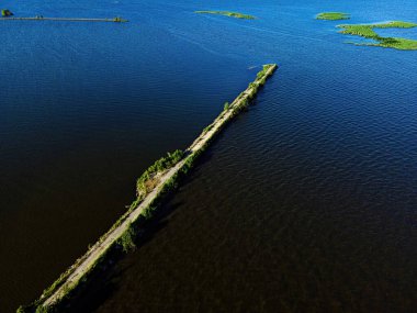 Summertime and its a desolate view of the path of the breakwall over the fox river in Oshkosh wisconsin