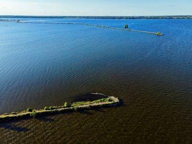 Summertime and its a desolate view of the path of the breakwall over the fox river in Oshkosh wisconsin