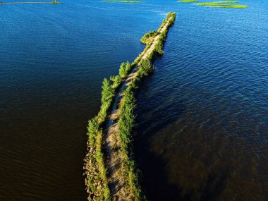 A desolate view as the sun shines brightly over the Fox River with a view of the breakwall near Oshkosh