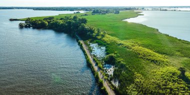 A desolate view as the sun shines brightly over the Fox River with a view of the breakwall near Oshkosh
