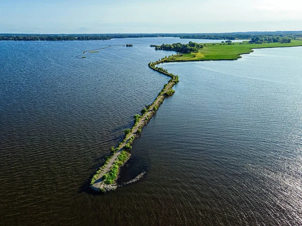 Summertime and its a desolate view of the path of the breakwall over the fox river in Oshkosh wisconsin