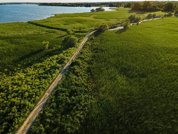 summertime in oshkosh wisconsin where the path leads out to the thin trail over the water