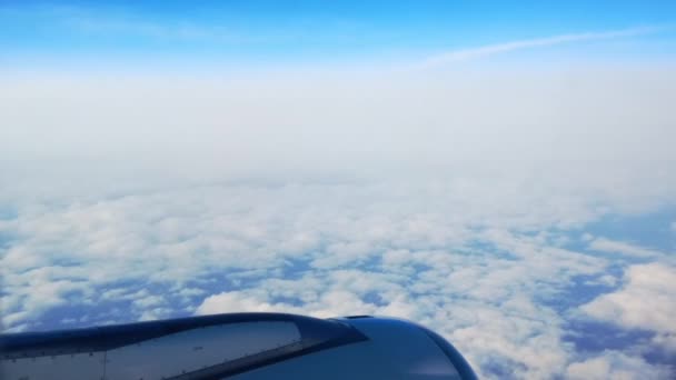 Beautiful view from plane seat. Cloudy weather with little blue sky — Stock Video