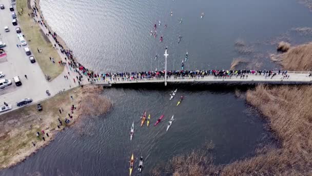 Aerial bird eyes view of young canoers going down through the bridge. Athletes — Stock Video