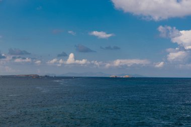 Paros island view and panorama from a ship on a beautiful colorful day, Cyclades, Aegean sea, Greece