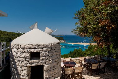 A crystal clear waters from the small wooden pier in the Voutoumi beach in the island of Antipaxoi, Ionian islands, Greece