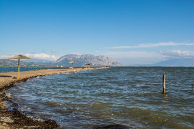 A stand alone umbrella at the beach of tourlida of Messologi, a uinque place on the sealake of Messologi, Aitolocarnania, Greece