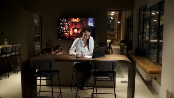 Ein Mädchen mit Dreadlocks im weißen Hemd, das in einer Online-Lektion ein digitales Tablet benutzt, lernt, eine Lektion aufzuschreiben. Am Ende blickt er in die Kamera. Online-Lernkonzept. — Stockvideo