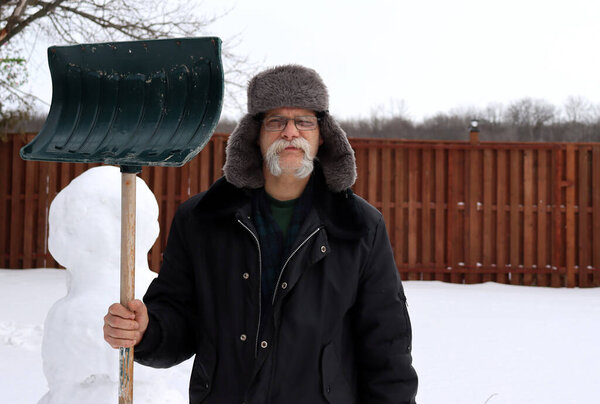 Man in winter with shovel 