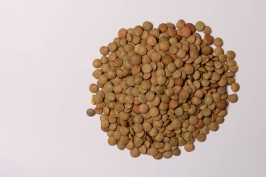 Beyaz arka planda organik yeşil mercimek taneleri. en üstteki görünüm