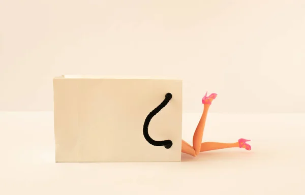 Kreatív Összetétel Fehér Papírzacskó Lány Lábak Rózsaszín Magassarkú Fényes Háttérrel — Stock Fotó
