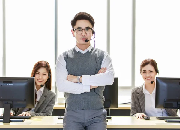 Portrait of team of diligent male and female call center colleagues are working to provide service and interact with customers. Service concept and working as a team.