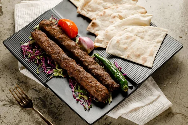 Lamb Kebab Platter with bread served in a dish isolated on grey background side view fast food