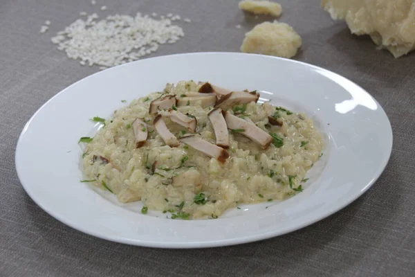 Smoked Chicken Risotto served in a dish isolated on grey background side view