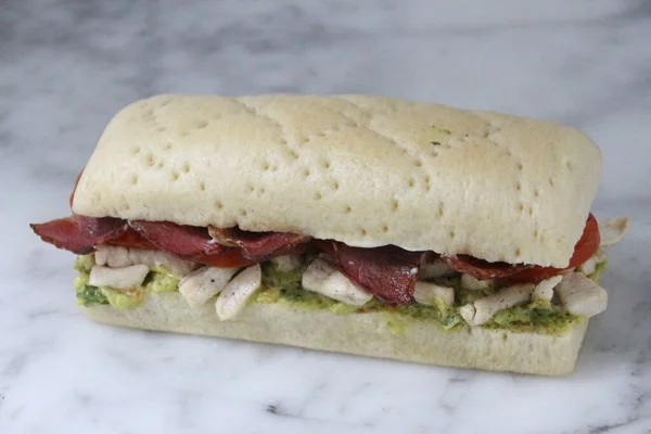 Grilled Chicken Bacon Avocado Sandwich isolated on grey background side view of fastfood