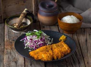 TORI KATSUDON with white rice and salad served in a dish isolated on wooden background side view of japanese food