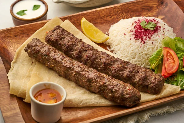 Chelo Kebab Rice Lime Salad Tomato Raita Sauce Served Dish — стоковое фото