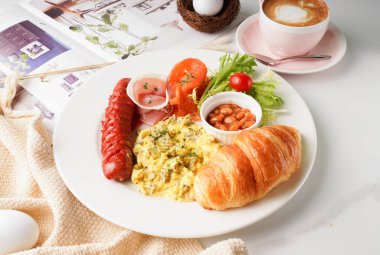All Day Breakfast with beans, toast, croissants, chinese sausage, sauce, egg and latte served in a dish isolated on table side view of english breakfast