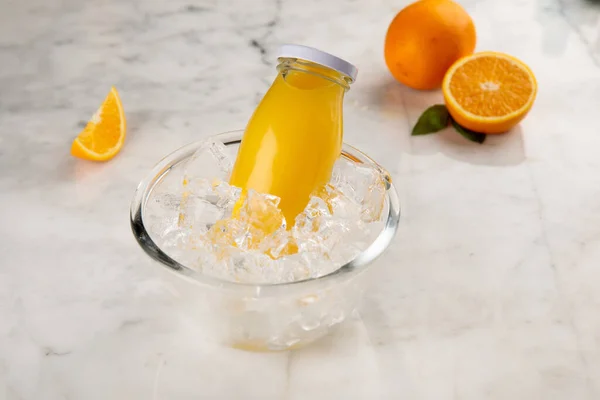 Bottle Fresh Orange Juice Served Iced Cube Bowl Side View — Stockfoto