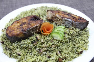 grilled King Fish rice served in a dish isolated on wooden background side view