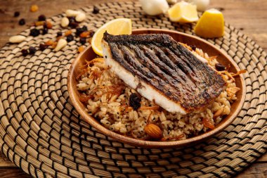 SAYADIYAH or SAYADIEH served in a dish isolated on wooden background side view