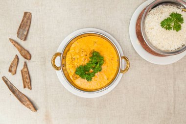 Chicken korma with plain rice served in a dish isolated on table top view of indian spices food