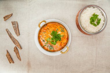 Chicken curry with plain rice served in a dish isolated on table top view of indian spices food