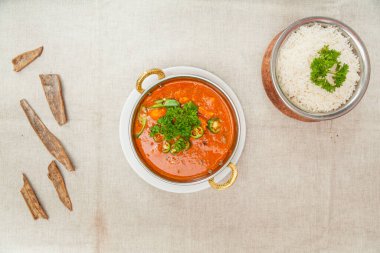 Chicken chili with plain rice served in a dish isolated on table top view of indian spices food