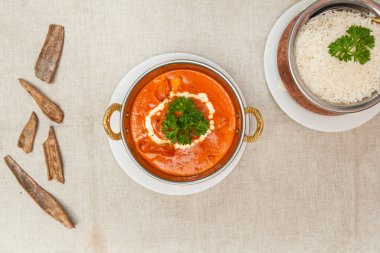 Butter chicken masala with plain rice served in a dish isolated on table top view of indian spices food