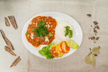 Kashimiri chicken chop masala with white rice and salad served in a dish isolated on table top view of indian spices food