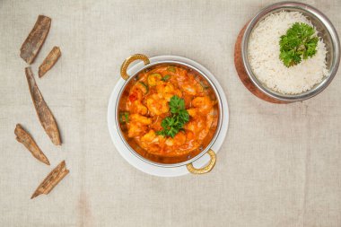 Jhinga jalfrezi or prawns jalfrezi with white rice served in a dish isolated on table top view of indian spices food